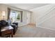 Inviting living area with carpet, features a staircase and a large window with exterior views at 11866 High Desert Rd, Parker, CO 80134