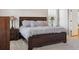 Comfortable main bedroom features an elegant wood frame bed, side tables, and lamp lighting at 11866 High Desert Rd, Parker, CO 80134