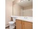 Well-lit bathroom featuring a single vanity and white tile at 8707 E Florida Ave # 709, Denver, CO 80247