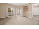 Spacious living room with neutral carpet and access to balcony at 8707 E Florida Ave # 709, Denver, CO 80247