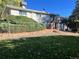 View of backyard and deck featuring lush greenery, fence, and brickwork at 2789 S Ivan Way, Denver, CO 80227