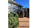 Brick patio with wooden deck, steps and white painted brick exterior at 2789 S Ivan Way, Denver, CO 80227