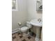 Traditional bathroom with pedestal sink, toilet, and decorative tile flooring at 2789 S Ivan Way, Denver, CO 80227