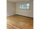 Bedroom with hardwood floors and a window featuring plantation shutters at 2789 S Ivan Way, Denver, CO 80227