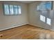 Bedroom with hardwood floors and bright natural light from shuttered windows at 2789 S Ivan Way, Denver, CO 80227