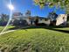 Well-maintained, single-story home with a brick chimney and lush green front yard at 2789 S Ivan Way, Denver, CO 80227