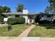 Charming single-story home features a well-manicured lawn, mature trees, and a welcoming entrance at 2789 S Ivan Way, Denver, CO 80227