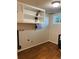 Laundry room with overhead cabinets, hardwood floors and a window at 2789 S Ivan Way, Denver, CO 80227
