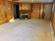 Living room with brick fireplace, built-in shelving and wood paneling at 2789 S Ivan Way, Denver, CO 80227
