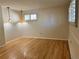 Open living room area featuring hardwood floors and contemporary light fixtures at 2789 S Ivan Way, Denver, CO 80227