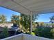 Balcony view overlooking mature trees, neighborhood rooftops, and a bright blue sky at 2789 S Ivan Way, Denver, CO 80227