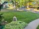A lovely green lawn with a large rock and landscaping sits adjacent to a sidewalk at 2789 S Ivan Way, Denver, CO 80227