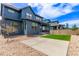Stylish home features a lush backyard with a concrete patio, gravel landscaping, and wood fence at 5608 Grandville Ave, Longmont, CO 80503