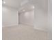 Unfinished basement with carpet flooring, white walls, and ample space for customization at 5608 Grandville Ave, Longmont, CO 80503