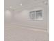 Spacious basement featuring carpet flooring, a window, and white walls, ready to customize at 5608 Grandville Ave, Longmont, CO 80503