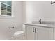 Powder room featuring a modern vanity with gray countertop and black hardware at 5608 Grandville Ave, Longmont, CO 80503