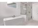 Modern bathroom features a freestanding tub and glass-enclosed shower at 5608 Grandville Ave, Longmont, CO 80503