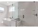 Sleek bathroom featuring a soaking tub and a glass-enclosed shower at 5608 Grandville Ave, Longmont, CO 80503