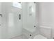 Modern tiled shower stall features a bench, a shower niche, and a glass enclosure at 5608 Grandville Ave, Longmont, CO 80503