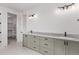 Bathroom with double vanity, marble counters, and walk-in closet access at 5608 Grandville Ave, Longmont, CO 80503
