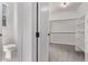 Bathroom with a toilet near the walk in closet with carpeted floors at 5608 Grandville Ave, Longmont, CO 80503