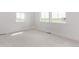Bright bedroom with white walls, carpet flooring, and three windows that let in ample natural light at 5608 Grandville Ave, Longmont, CO 80503