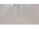 Neutral bedroom featuring crisp white walls, plush carpeting, and modern baseboards at 5608 Grandville Ave, Longmont, CO 80503
