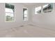 Bright and airy bedroom featuring hardwood floors and three windows with scenic neighborhood views at 5608 Grandville Ave, Longmont, CO 80503
