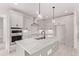Newly remodeled kitchen featuring an oversized island with seating, white cabinetry and updated appliances at 5608 Grandville Ave, Longmont, CO 80503