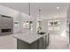 Open kitchen and living space, featuring an oversized island and a sleek fireplace at 5608 Grandville Ave, Longmont, CO 80503