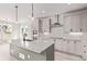 Bright kitchen features a large island, pendant lighting, and stainless steel appliances at 5608 Grandville Ave, Longmont, CO 80503