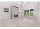 Bright, open-concept living room with high ceilings and a stunning modern fireplace at 5608 Grandville Ave, Longmont, CO 80503