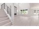 Spacious living room with a modern fireplace, staircase, and lots of natural light at 5608 Grandville Ave, Longmont, CO 80503