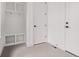 Clean, modern mudroom with built in storage and neutral tile floors at 5608 Grandville Ave, Longmont, CO 80503