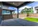 Covered patio with concrete flooring, black metal railing, and a view of the fenced backyard at 5608 Grandville Ave, Longmont, CO 80503