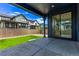 Covered patio with concrete flooring, a manicured lawn, and a view of the fenced backyard at 5608 Grandville Ave, Longmont, CO 80503