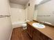 Bathroom with a tub, toilet and wood vanity at 1074 S Dearborn St # 306, Aurora, CO 80012