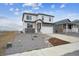 Beautiful home exterior featuring stone accents, a well-maintained yard, and a two-car garage at 8322 E 134Th Pl, Thornton, CO 80602