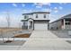 Two-story home showcasing stylish exterior with stone accents, manicured front yard, and attached two-car garage at 8322 E 134Th Pl, Thornton, CO 80602