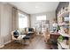 Stylish office with built-in shelving, large windows, a cozy seating area, and contemporary decor at 8322 E 134Th Pl, Thornton, CO 80602