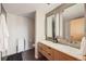 Modern bathroom featuring double vanity sinks, large mirrors, and updated fixtures at 2100 16Th St # 408, Denver, CO 80202