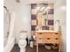 Stylish bathroom with modern vanity, integrated sink, and checkered tile design, complementing the tub with shower at 2100 16Th St # 408, Denver, CO 80202