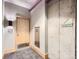 Hallway with a door, carpet, and wall-mounted light, leading to the stairwell, promoting safety and style at 2100 16Th St # 408, Denver, CO 80202