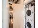 Convenient laundry room featuring stacked washer and dryer, optimizing space within the modern home at 2100 16Th St # 408, Denver, CO 80202