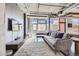 Open concept living room featuring modern design and large windows at 2100 16Th St # 408, Denver, CO 80202