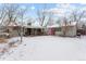 A spacious backyard with a covered deck and a shed painted in neutral color with a vibrant pink door at 7135 W 24Th Ave, Lakewood, CO 80214