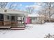 Backyard featuring a wooden deck with a covered area leading to a storage shed with a pink door at 7135 W 24Th Ave, Lakewood, CO 80214