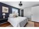 Comfortable bedroom featuring cozy bedding, a ceiling fan, and a window with a view at 7135 W 24Th Ave, Lakewood, CO 80214