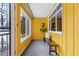 Bright and welcoming enclosed entryway featuring large windows, a comfortable bench, and vibrant yellow walls at 7135 W 24Th Ave, Lakewood, CO 80214