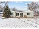 Charming single-story home featuring large picture windows and a well-maintained front yard covered in a layer of fresh snow at 7135 W 24Th Ave, Lakewood, CO 80214